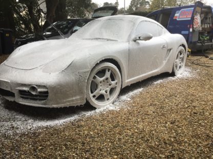 A Black Porsche Caymen enjoying a Super 8 Snow bathe